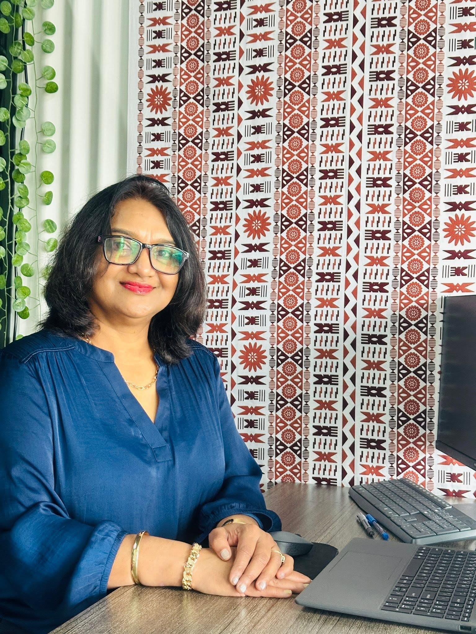 Priya Pratap, Founder and Licensed Immigration Adviser, at her desk